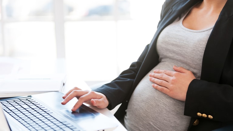 Pregnant businesswoman sitting at desk