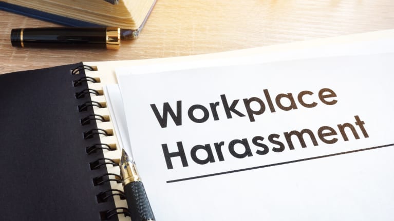 Workplace harassment written on a sheet of paper in boldface