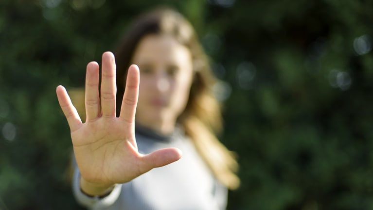 woman holding hand up to say stop