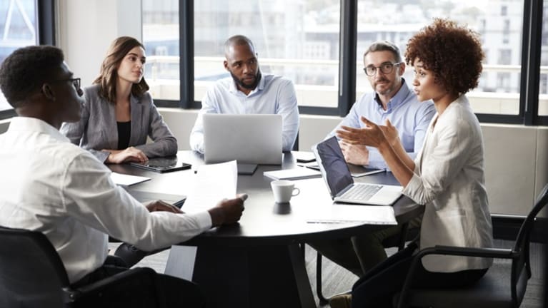 black and white workers at meeting