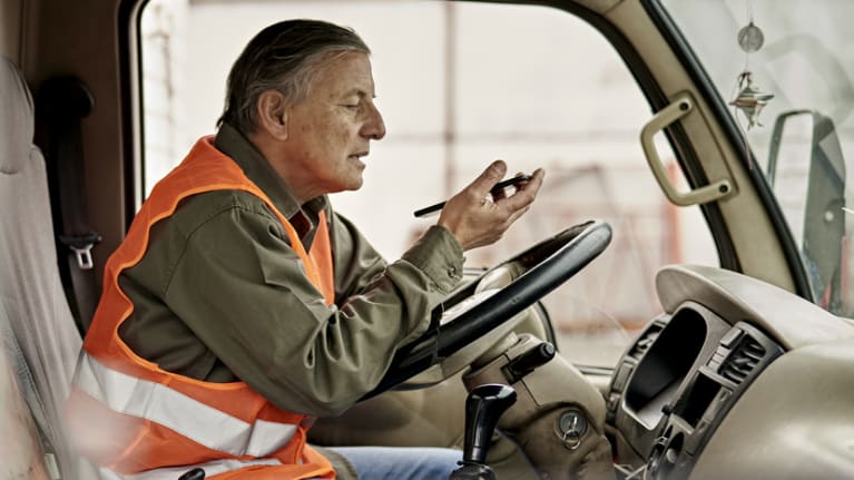 truck driver looking at handheld device