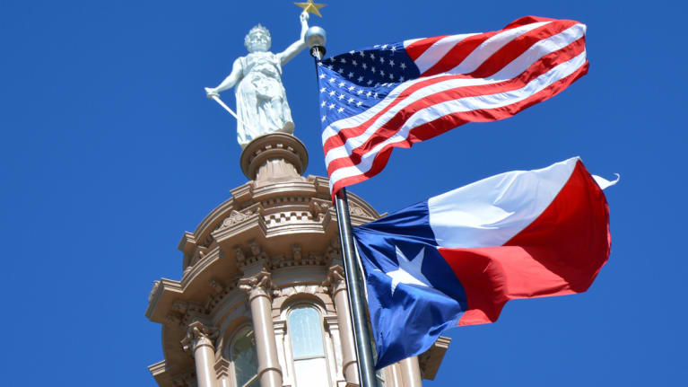 Texas Capitol with American and Texas Flags
