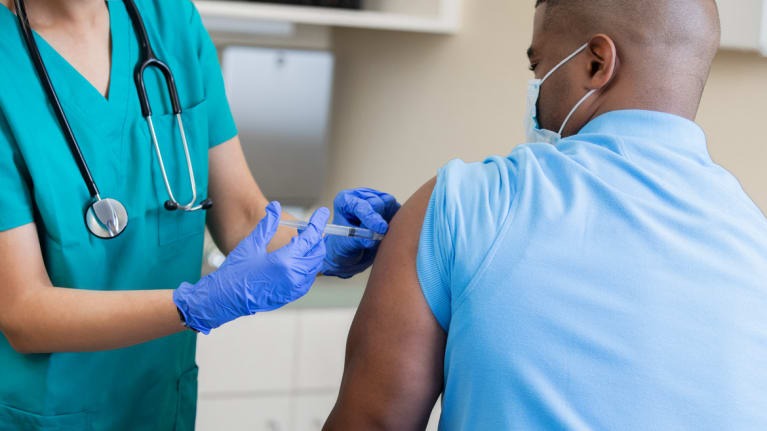 Someone getting a vaccine shot