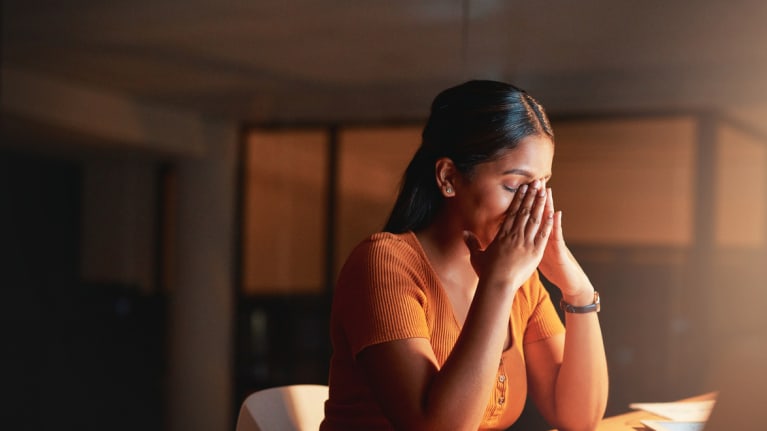 Stressed out employee with closed eyes and hand to head