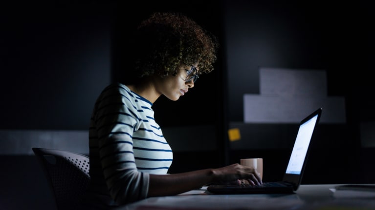women working at desk at night