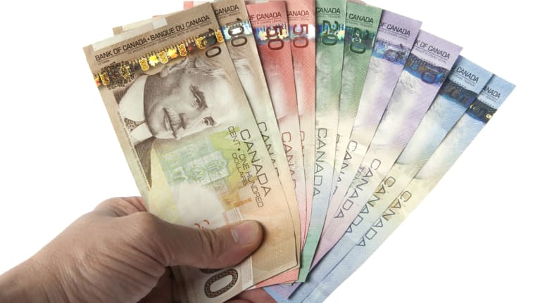Canadian currency held in someone&#39;s hand