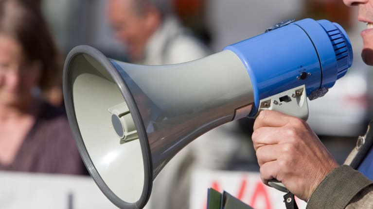 Person talking in a blow horn