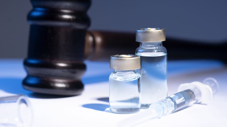 A gavel and COVID-19 vaccine