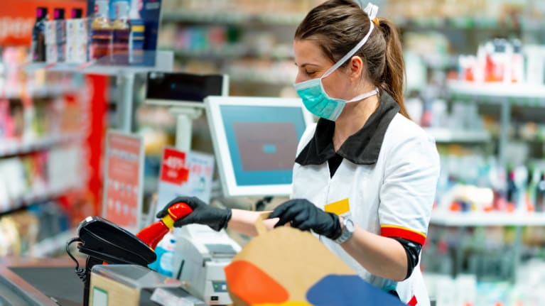 cashier with facemask and gloves