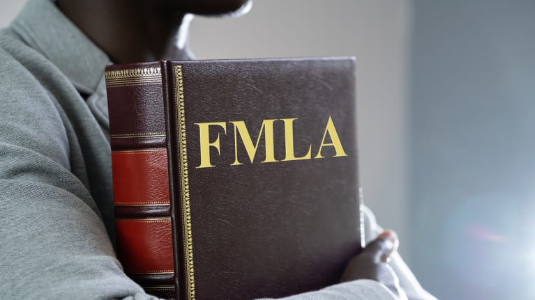 man holding FMLA law book