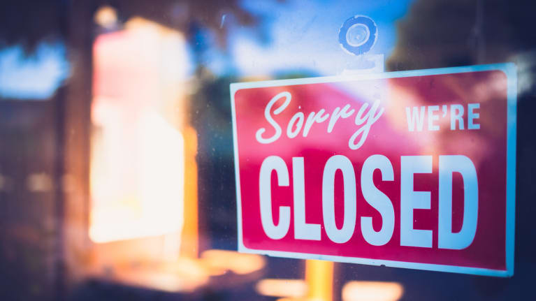A sign at the entrance of a business that says &quot;Sorry, we&#39;re closed.&quot;