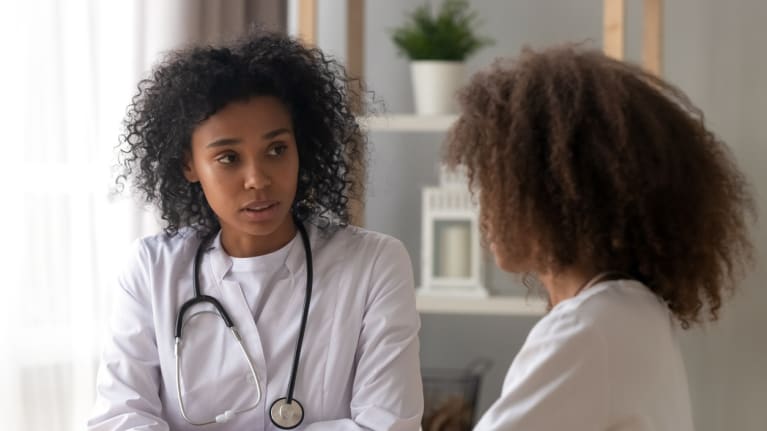 doctor talking with young patient