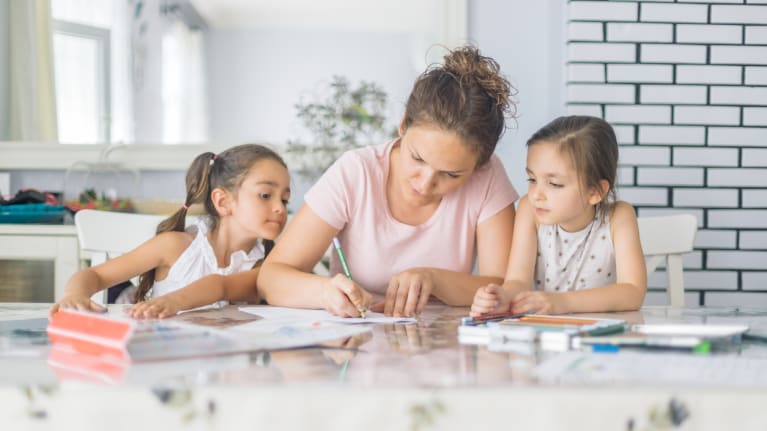 woman doing school work with children at home