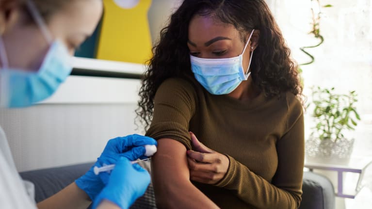 woman receiving vaccine shot