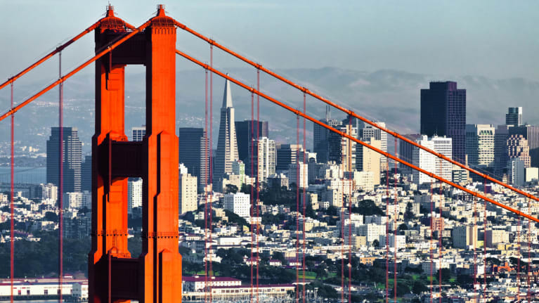 the Golden Gate Bridge in the foreground with the San Francisco skyline in the background