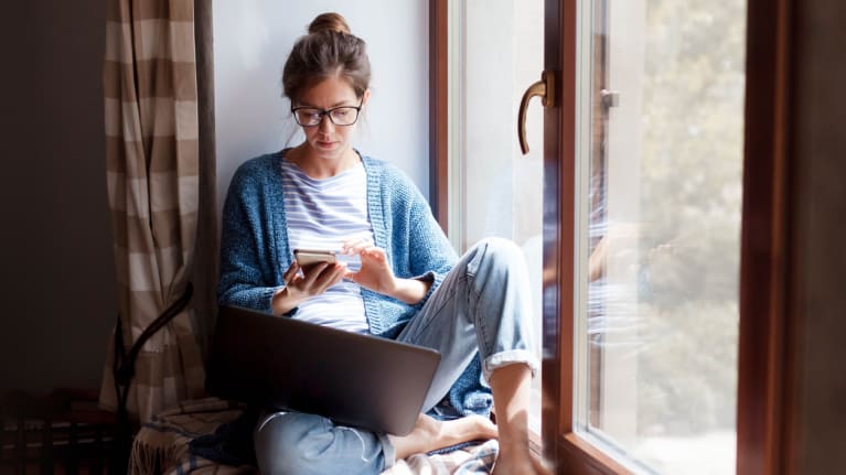 woman working from home on window seat