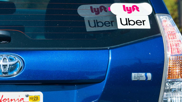 Lyft and Uber logos on car