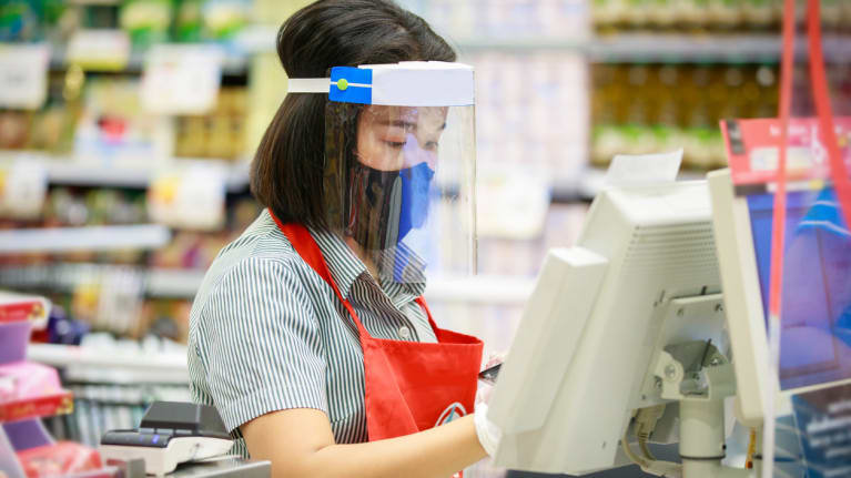 supermarket staff in protective mask and face shield