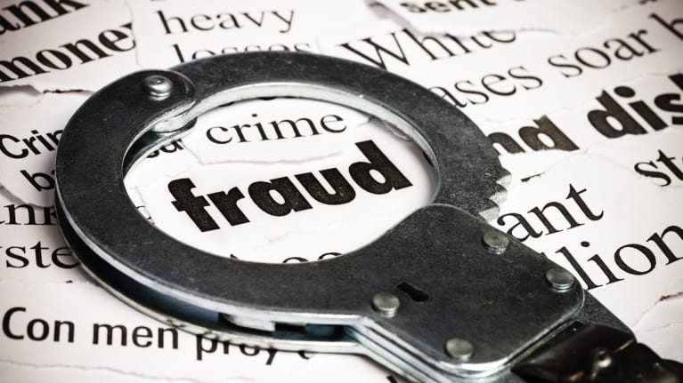 The word fraud with a handcuff over it