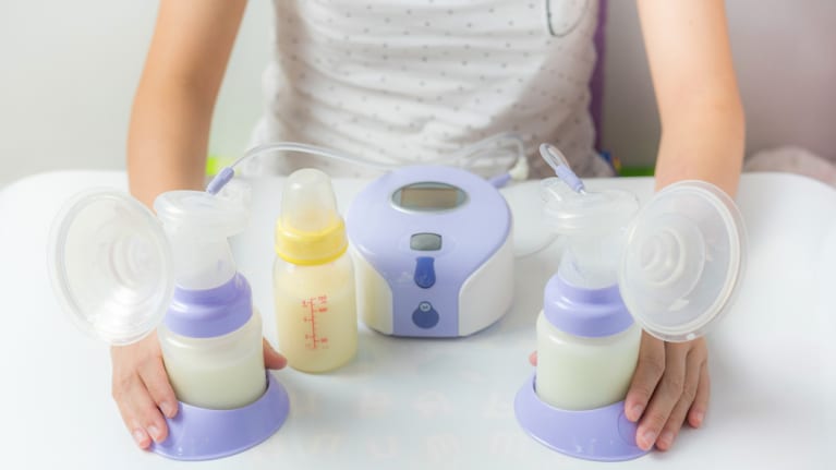 woman with breastpump and bottles