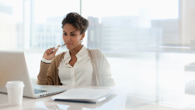 Businesswoman using laptop in office