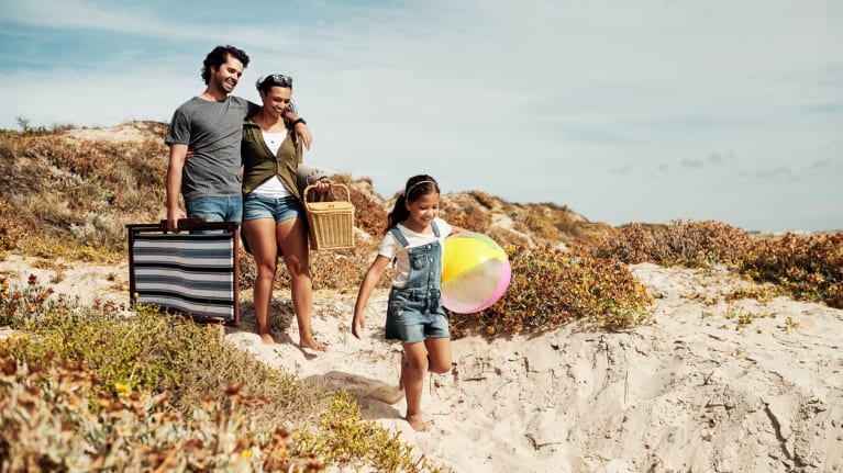 a couple and their child at the beach