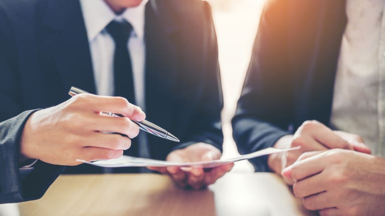 businessmen reviewing contract