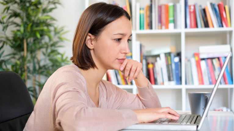 woman searching for information on laptop