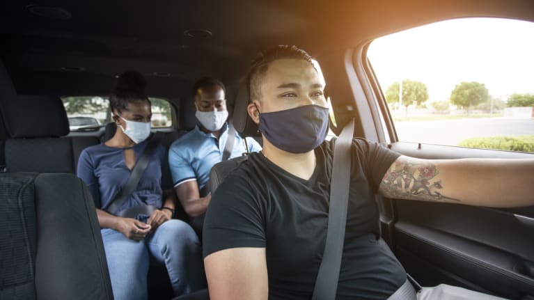 ride-hailing driver and passengers wearing face masks
