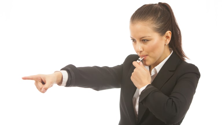 woman blowing whistle and pointing finger 