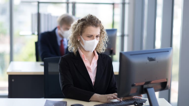 masked employees in office setting