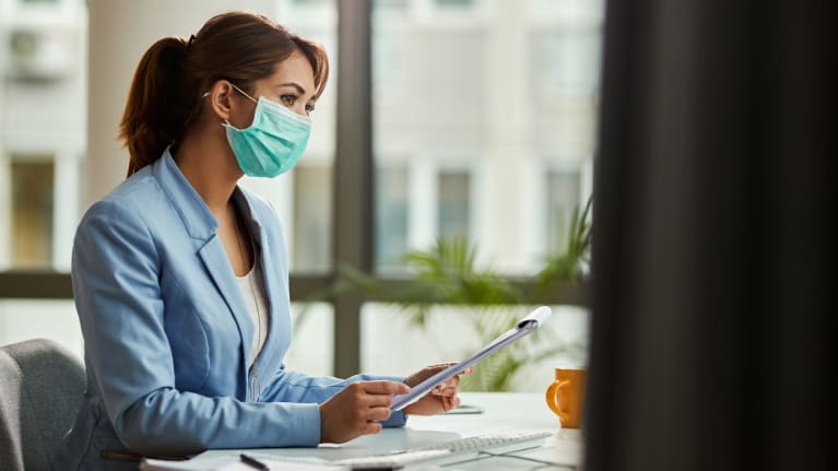 Businesswoman wearing face mask in the office