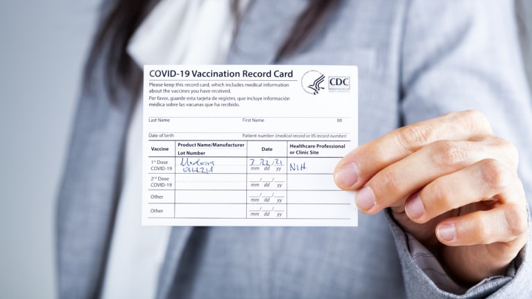 woman shows vaccination record