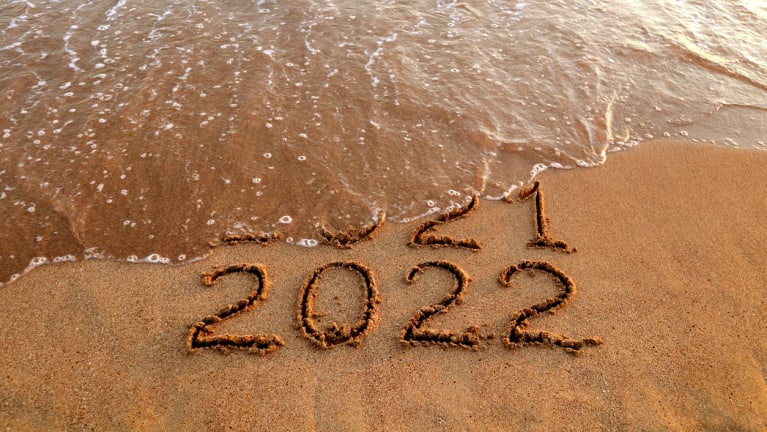 New year 2022 and 2021 on sandy beach