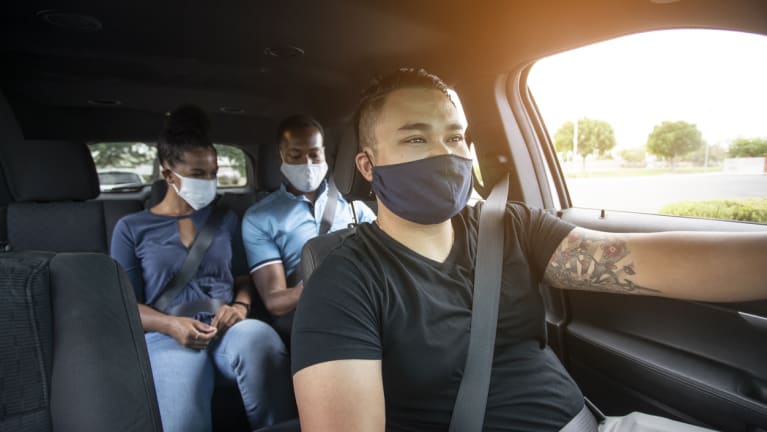 Ride-share driver and passengers wearing masks