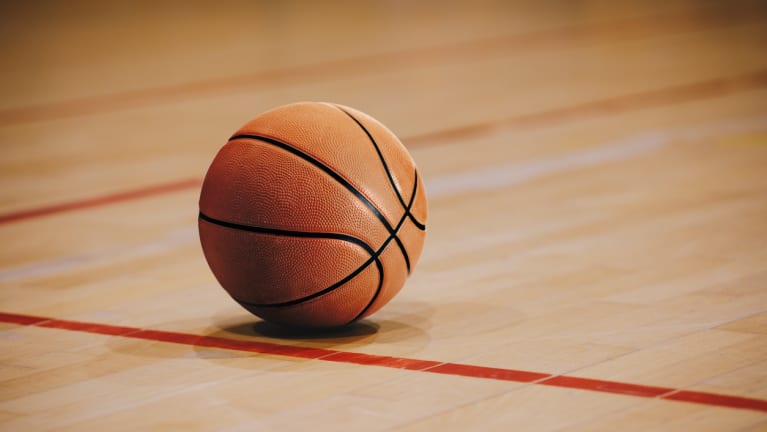 Basketball on Wooden Court Floor