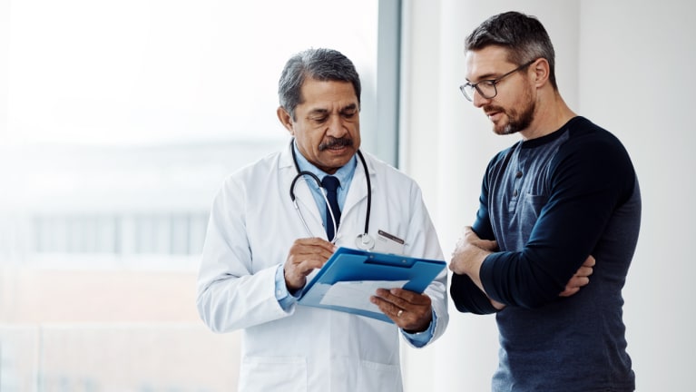 doctor looking at paperwork with patient
