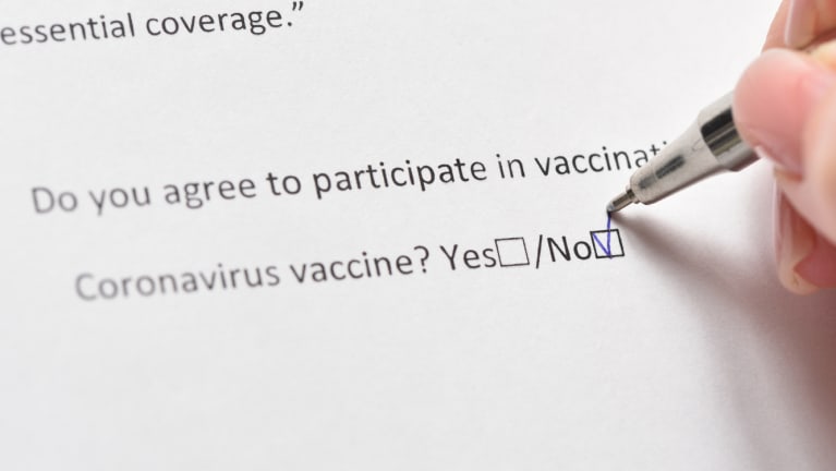 someone marking on a form that they will not be vaccinated againsts COVID-19