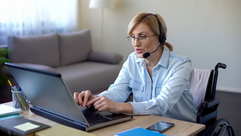 Woman who uses a wheelchair in a conference call through her computer