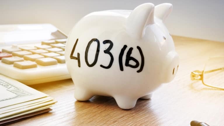 A picture of a white piggy bank with 403b written on it