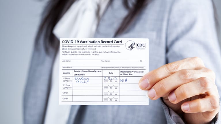 woman holding vaccine card