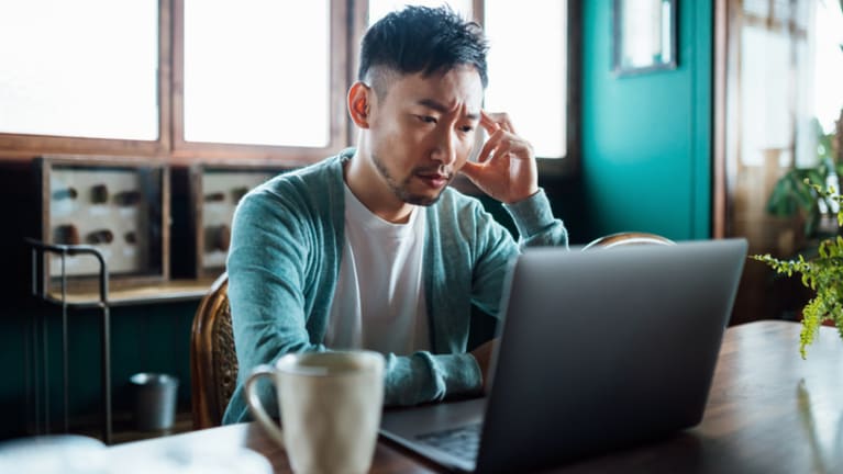 man worried at computer
