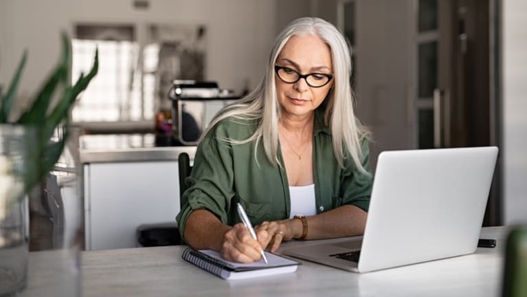 Woman researching investment funds online.