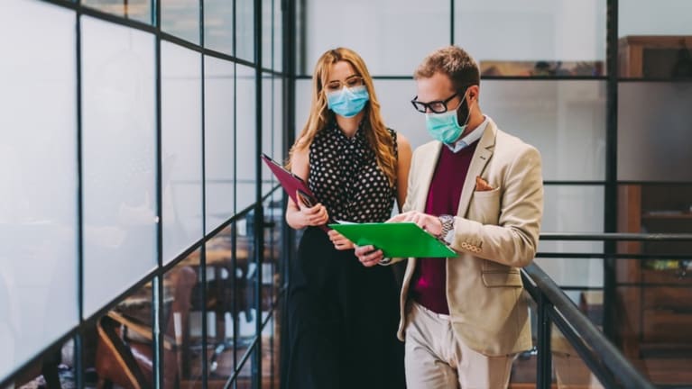 office workers wearing surgical masks