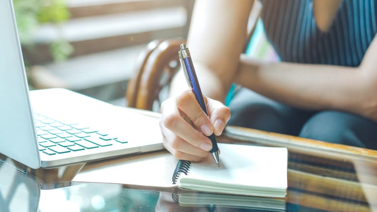 taking notes at computer