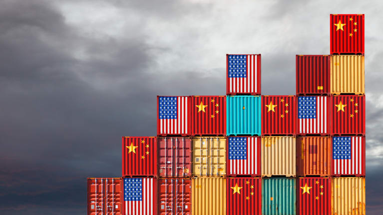 Alternating U.S. and Chinese flags on the sides of cargo shipping containers